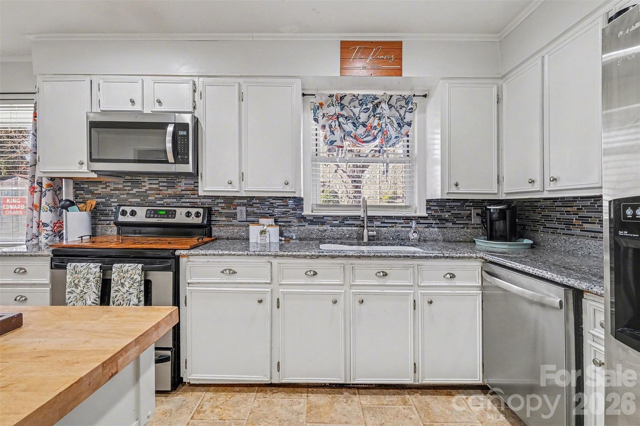 216 Malcolm Road Salisbury, NC 28144 - Photo 6 of 38 a kitchen with white cabinets sink and stainless steel appliances