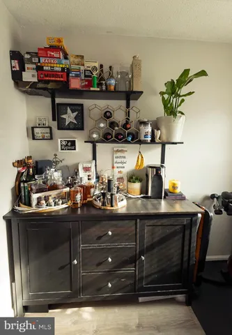 a kitchen with stainless steel appliances granite countertop a refrigerator a sink dishwasher a stove and a refrigerator