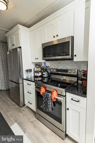 a view of a a dining room with furniture window and wooden floor