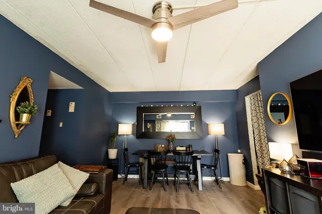 a view of a hallway with wooden floor and closet