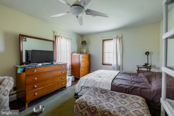 a bedroom with a bed and flat screen tv
