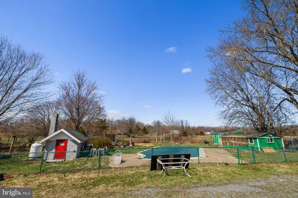 a view of backyard with swimming pool and outdoor seating