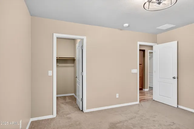 an empty room with wooden floor and a window