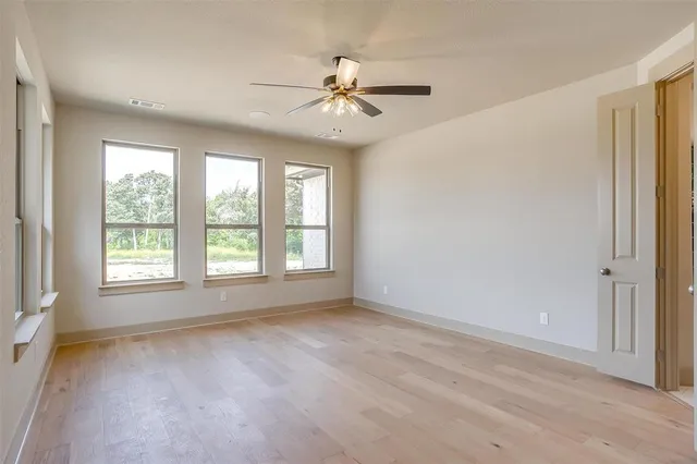a view of a livingroom with a ceiling fan and window