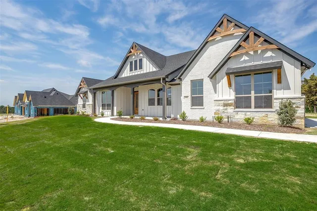 a view of a house with a yard and sitting area