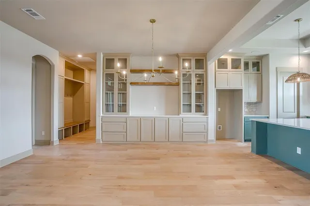a view of kitchen with granite countertop cabinets and refrigerator