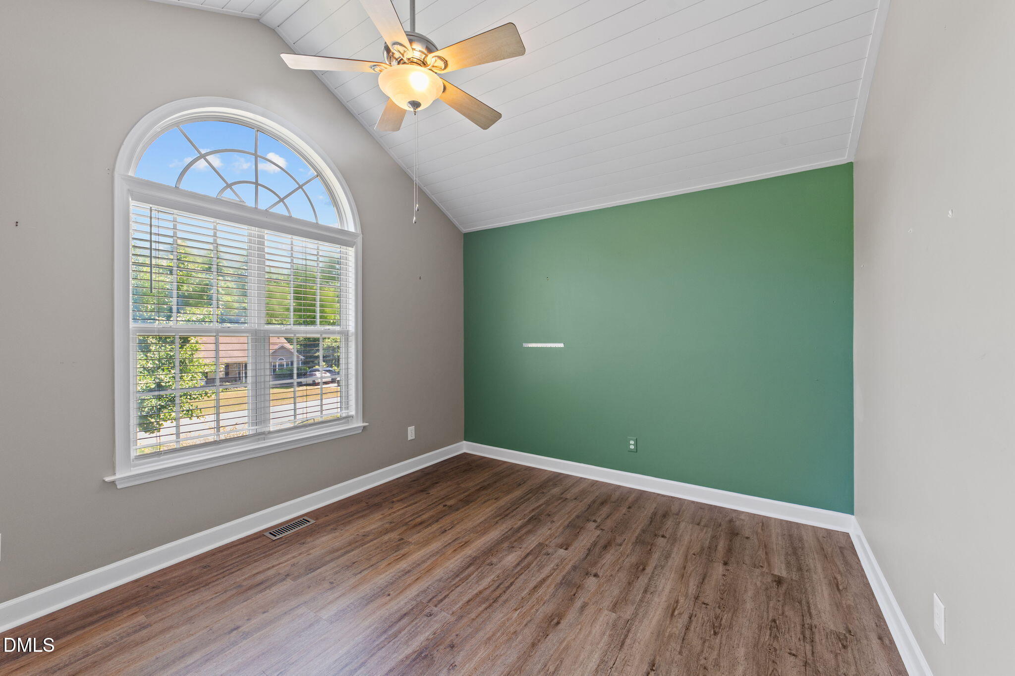 6820 Oviedo Drive Raleigh, NC 27603 - Photo 30 of 50 an empty room with wooden floor fan and windows