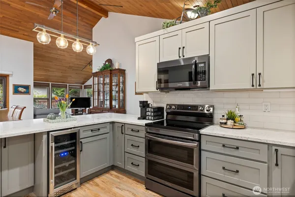 a kitchen with appliances a sink and cabinets