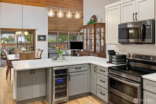 a kitchen with stainless steel appliances a stove microwave and cabinets