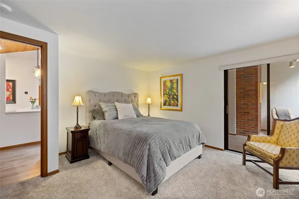 a spacious bedroom with a bed and a couch