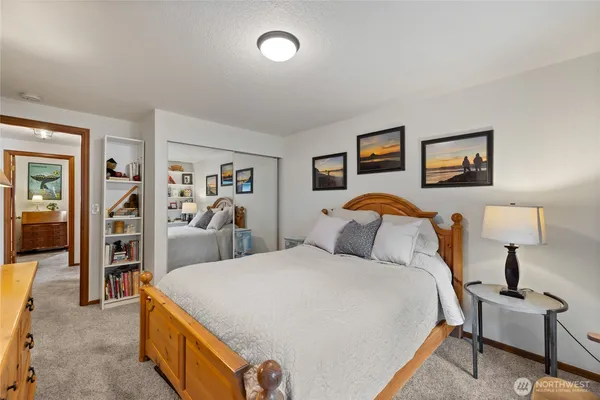 a bedroom with a bed and a lamp on table