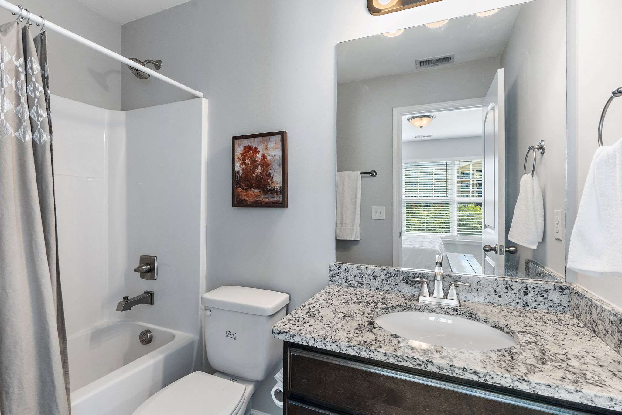 312 McKenzie Pass Madison, TN 37115 - Photo 18 of 21 a bathroom with a granite countertop sink a toilet and shower