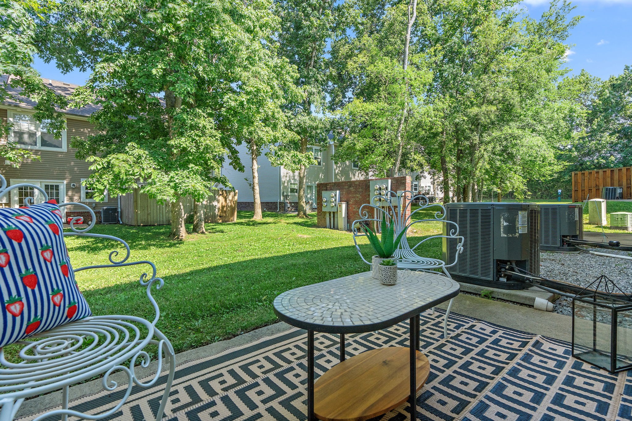 312 McKenzie Pass Madison, TN 37115 - Photo 20 of 21 a view of a backyard with table and chairs with wooden fence and plants