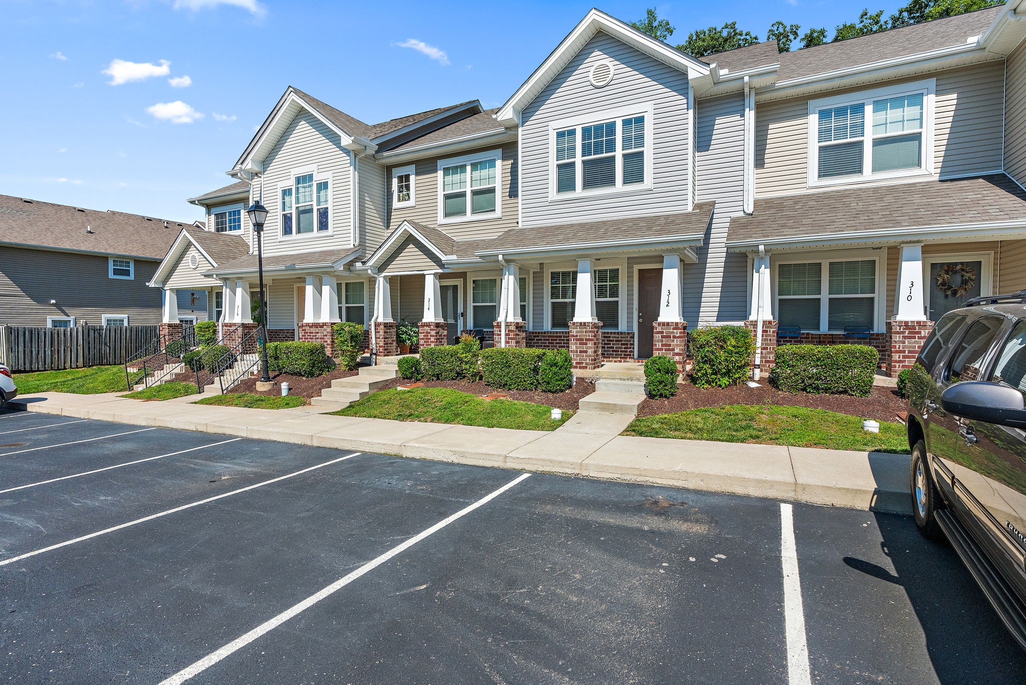 312 McKenzie Pass Madison, TN 37115 - Photo 2 of 21 a front view of a house with a yard and potted plants