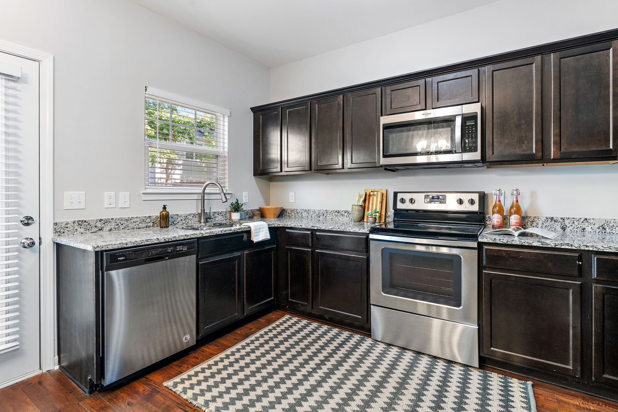 312 McKenzie Pass Madison, TN 37115 - Photo 9 of 21 a kitchen with stainless steel appliances granite countertop a stove a sink and a microwave