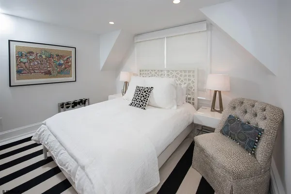 a bedroom with bed and a painting