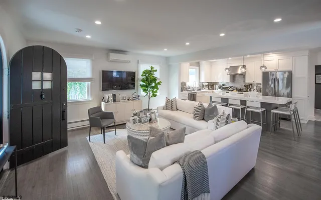 a living room with fireplace furniture and a flat screen tv
