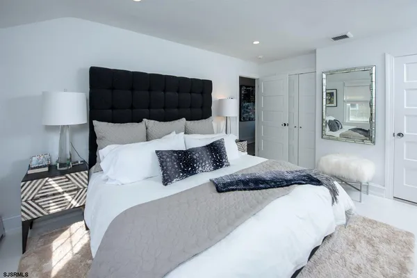 a bedroom with a bed and a lamp