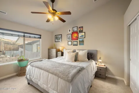 a bedroom with a bed and a large window