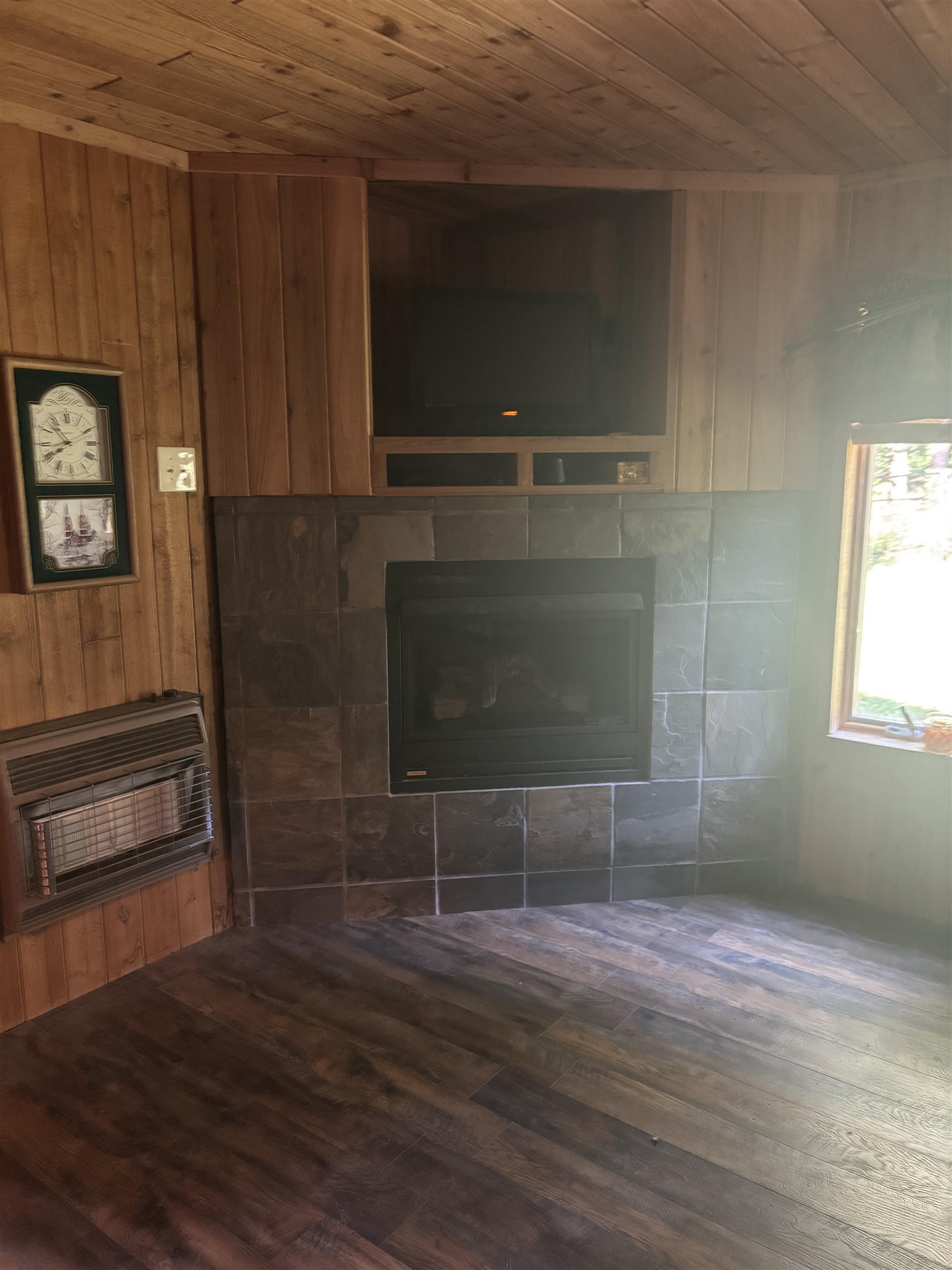 7462 Campground Road Drummonds, TN 38023 - Photo 15 of 31 Wood-finish flooring with a stone-tiled fireplace surround