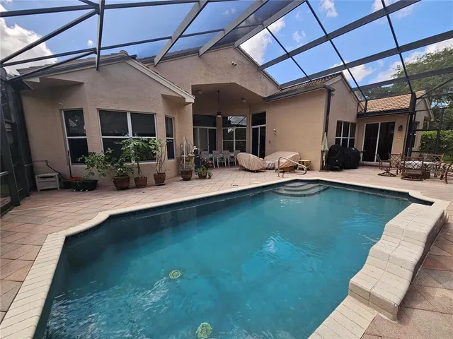 a view of a backyard with swimming pool