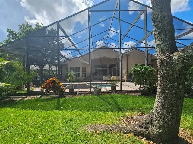 a view of a patio with table and chairs under an umbrella