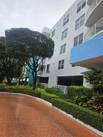 a view of a building with a yard