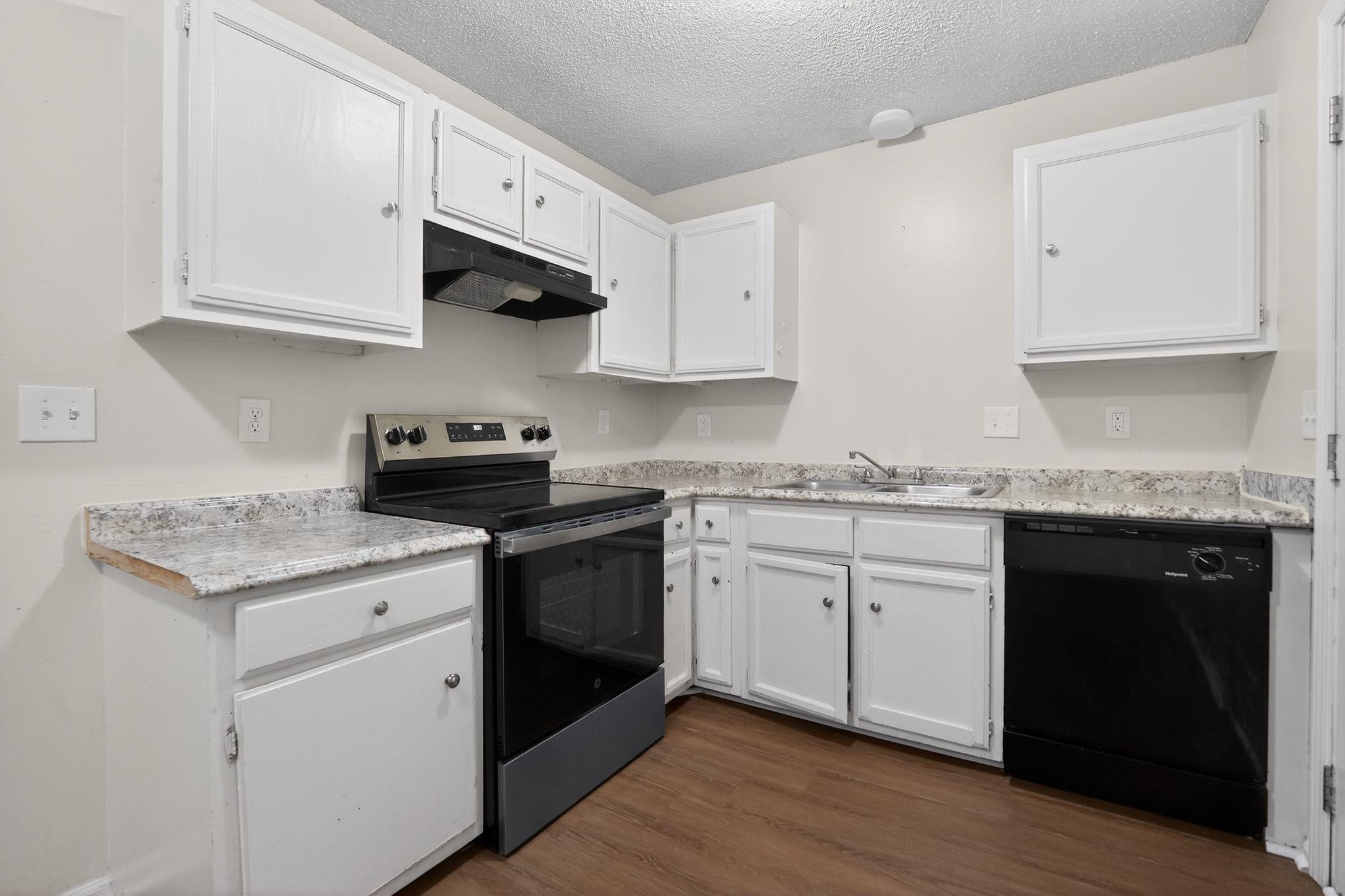 4725 Lofts Road Memphis, TN 38118 - Photo 16 of 32 Kitchen featuring stainless steel range with electric cooktop, white cabinets, dishwasher, light countertops, and a textured ceiling
