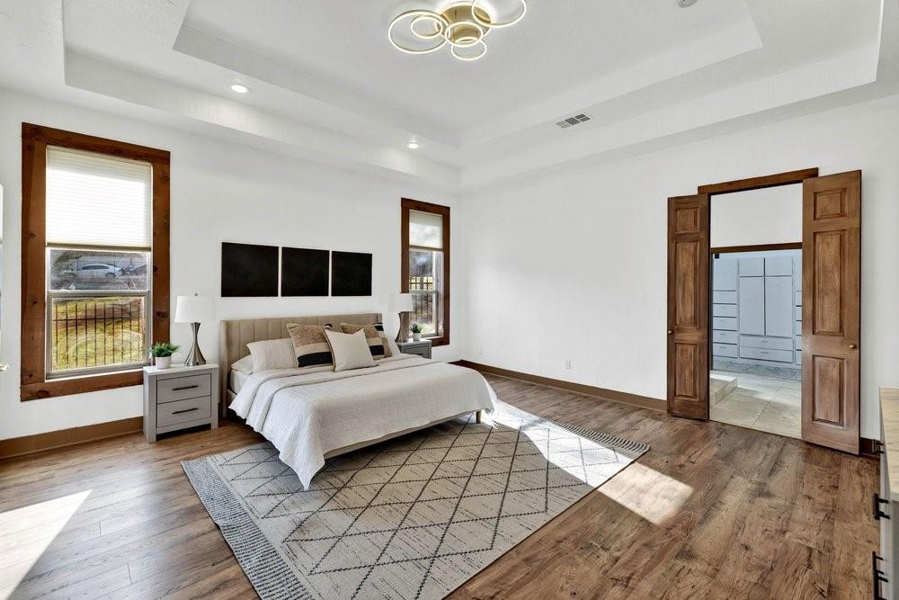 324 Rolling Oaks Ridge Cedar Hill, TX 75104 - Photo 15 of 39 a bedroom with a large bed and a large window