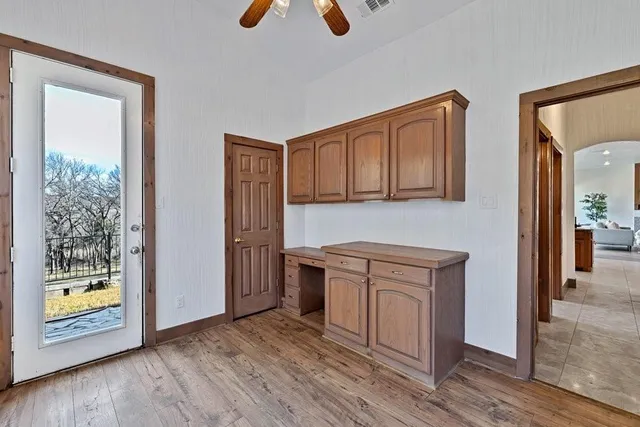 a view of a room with wooden floor and window