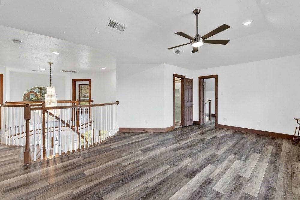 324 Rolling Oaks Ridge Cedar Hill, TX 75104 - Photo 24 of 39 a view of a room with wooden floor ceiling fan and window