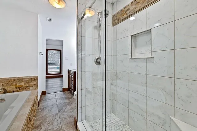 a bathroom with a granite countertop toilet sink and mirror