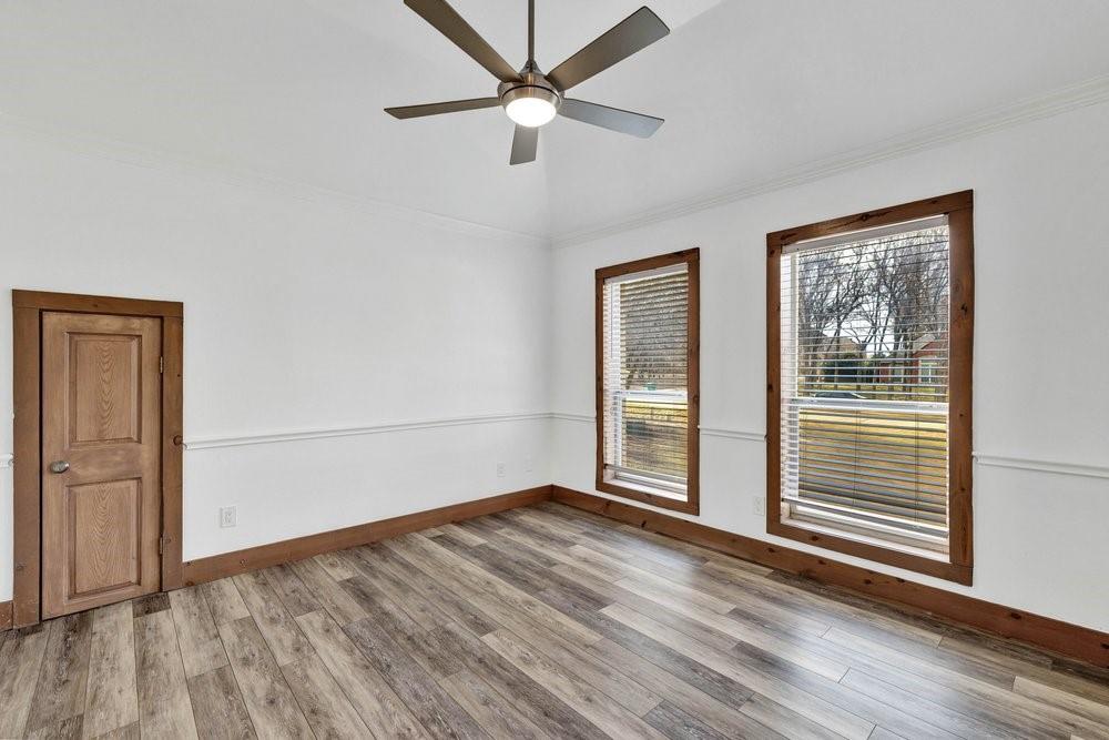 324 Rolling Oaks Ridge Cedar Hill, TX 75104 - Photo 31 of 39 an empty room with wooden floor fan and windows