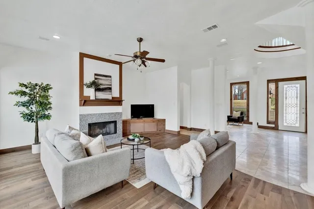 a living room with furniture and a potted plant