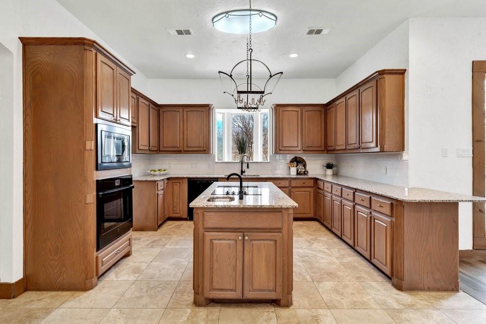 324 Rolling Oaks Ridge Cedar Hill, TX 75104 - Photo 6 of 39 a kitchen with stainless steel appliances granite countertop a sink dishwasher stove and cabinets
