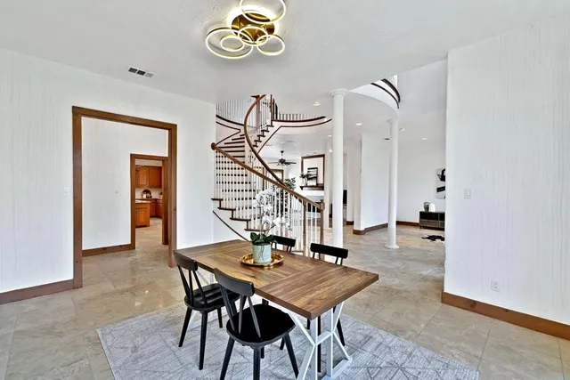 a view of a workspace room with furniture and window