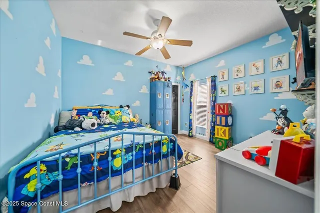 a bedroom with baby crib and book shelf
