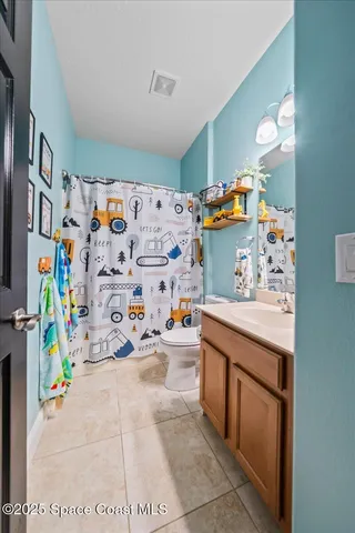 a utility room with stainless steel appliances cabinets and a couch
