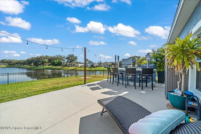 a view of a swimming pool and outdoor seating