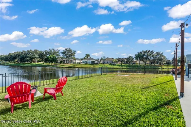a lake view with a swimming pool and a yard