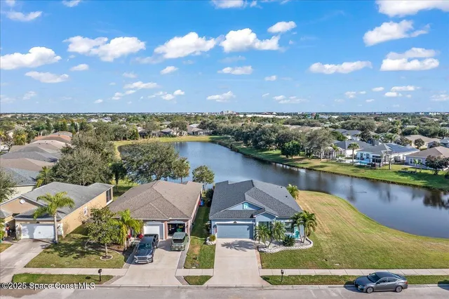 an aerial view of a house with a lake view