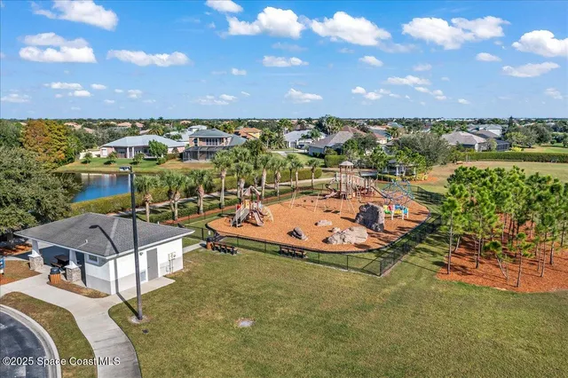 a view of a swimming pool with lawn chairs under an umbrella