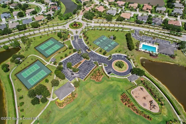 an aerial view of a house with garden space and windows