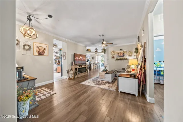 a living room with lots of furniture and wooden floor