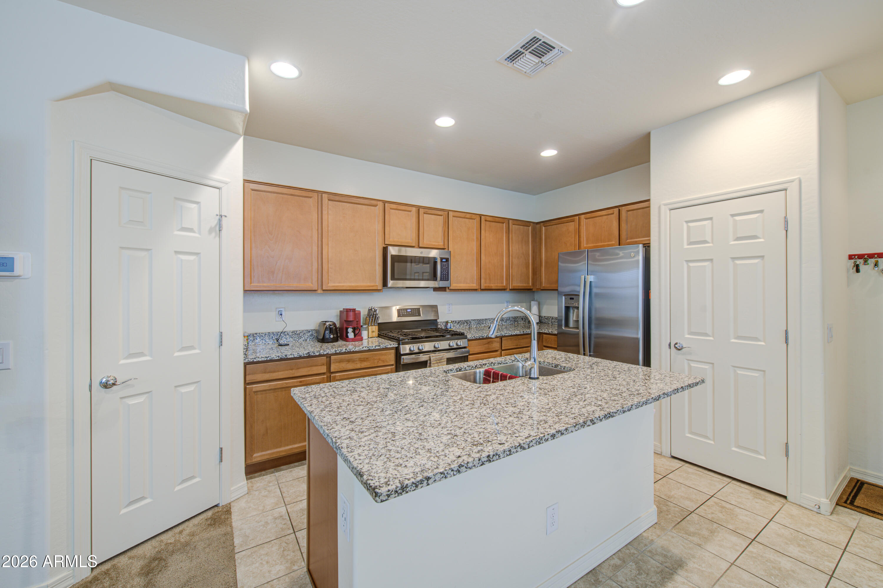 1705 South 83rd Way Mesa, AZ 85209 - Photo 13 of 39 a kitchen with stainless steel appliances granite countertop a sink refrigerator and cabinets