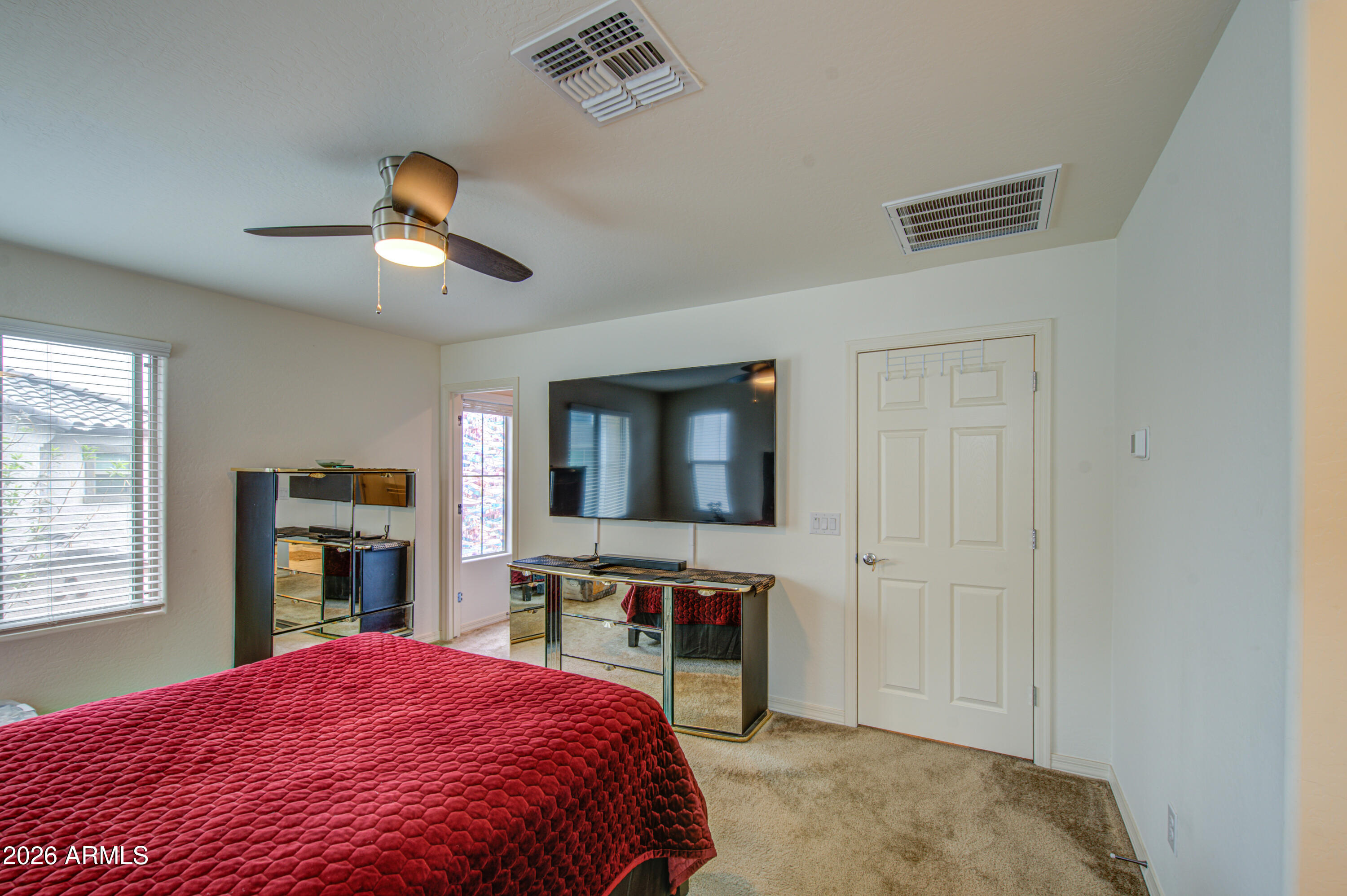 1705 South 83rd Way Mesa, AZ 85209 - Photo 19 of 39 a bedroom with a bed and a flat screen tv