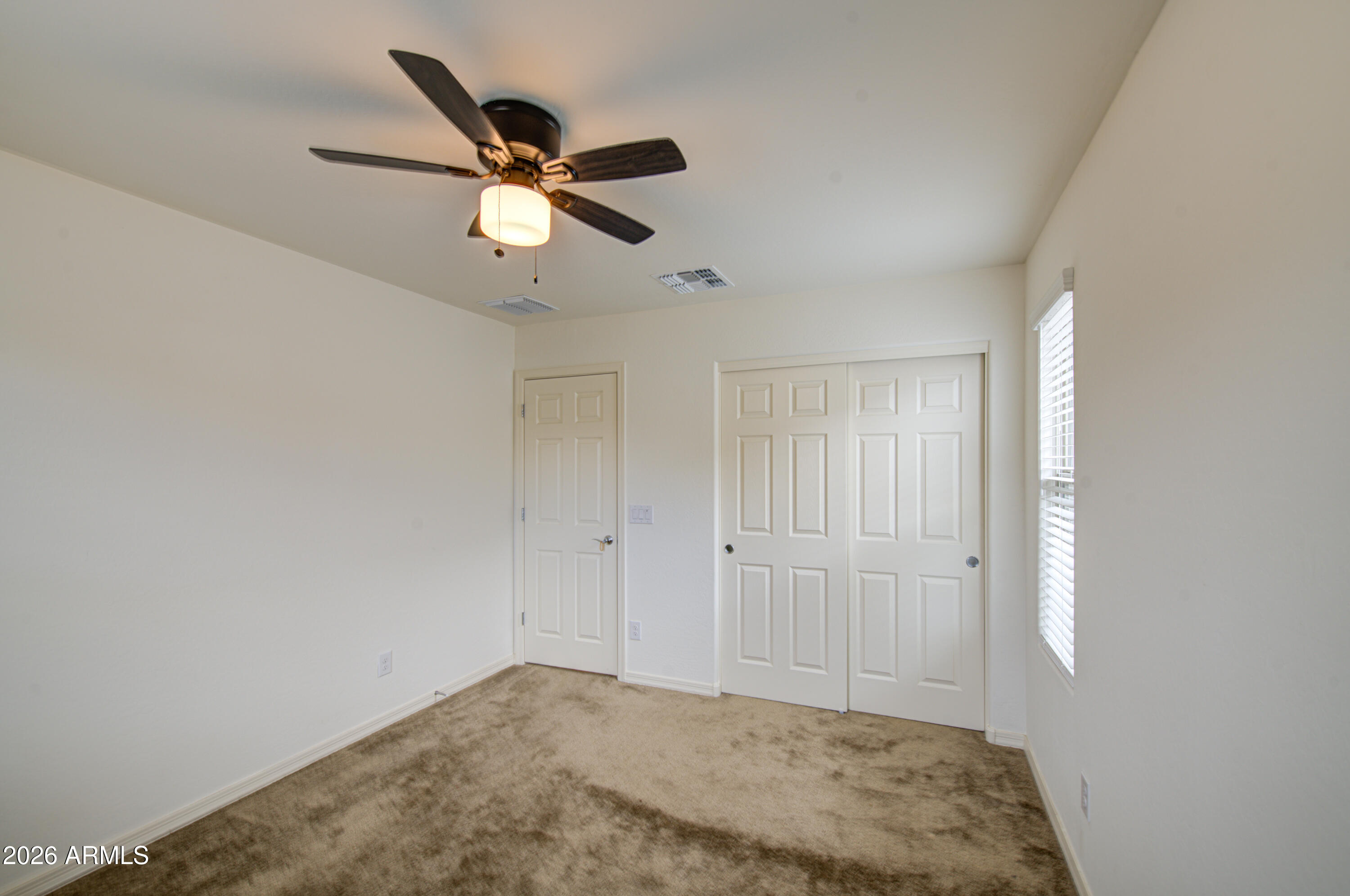 1705 South 83rd Way Mesa, AZ 85209 - Photo 27 of 39 a view of empty room with window and ceiling fan