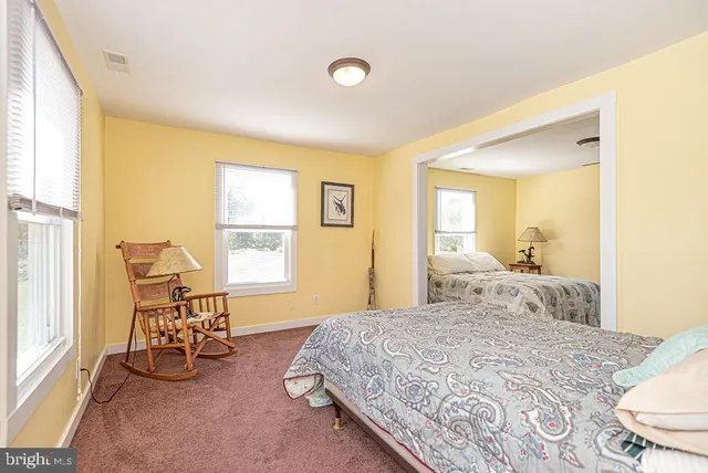 a view of a house with pool and chairs