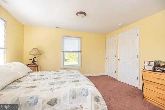 a view of a lake with deck in front of house