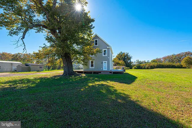 an aerial view of a house with a yard basket ball court and outdoor seating